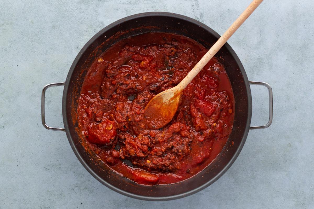 tomato sauce, seasonings, and broth in a bowl.