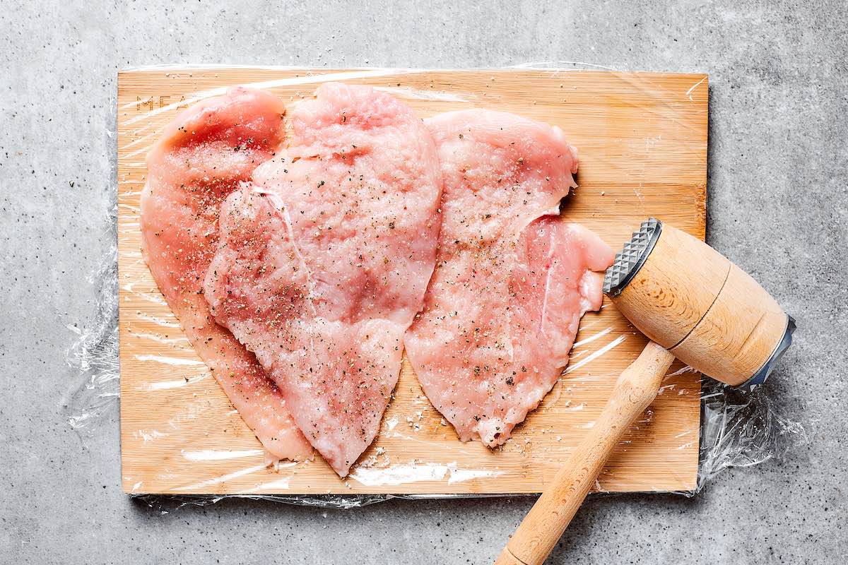 pounding raw chicken breasts.