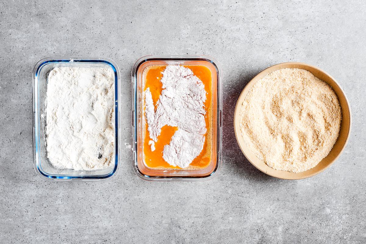 dredging raw chicken in flour and egg.