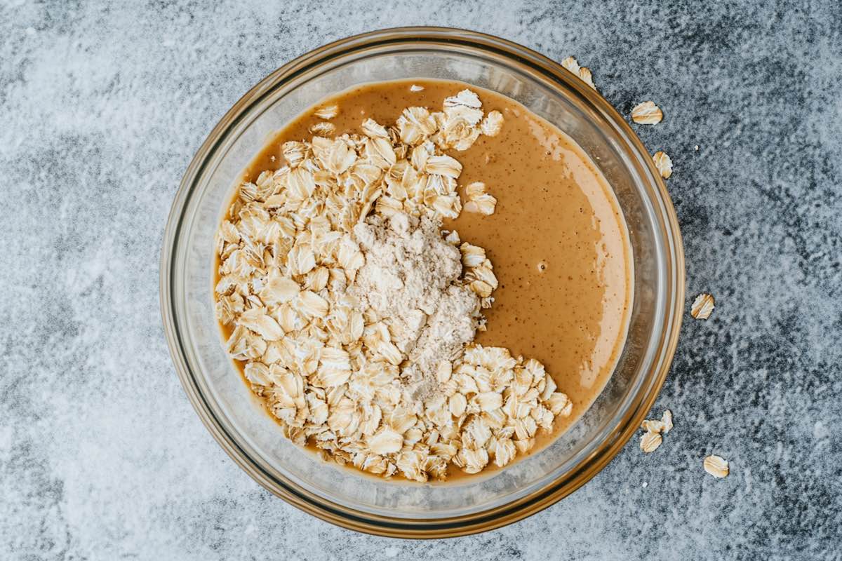 oats, peanut butter, maple syrup, and protein powder in a bowl.