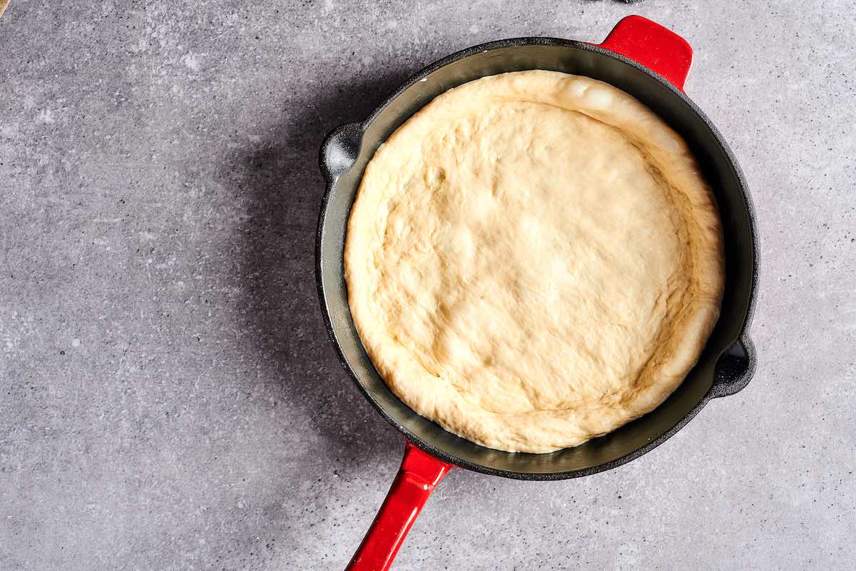 pizza dough in a cast iron skillet.