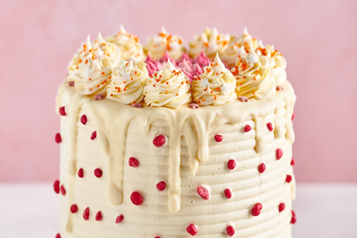 frosted cake with decorations on top.