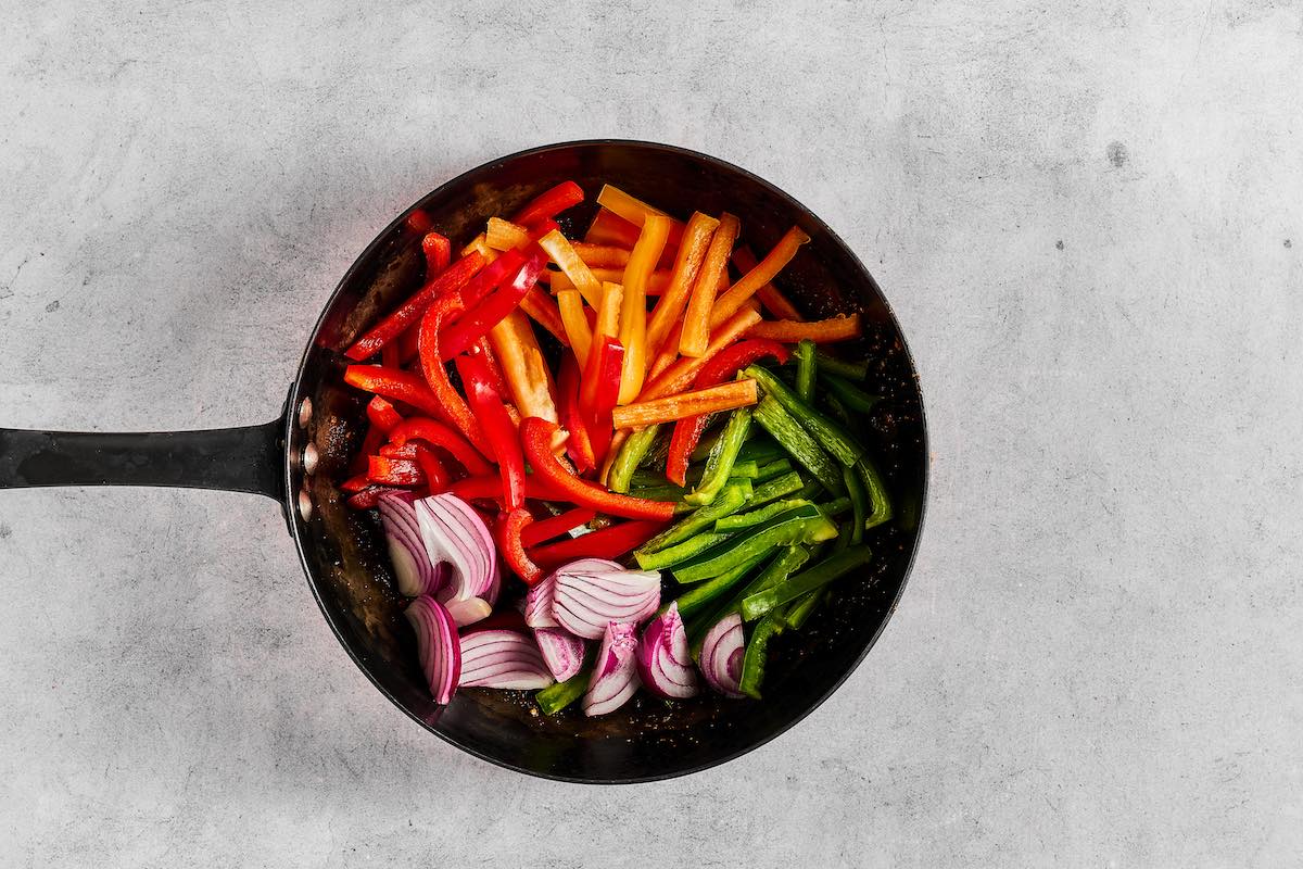 vegetables sauteing in a skillet.