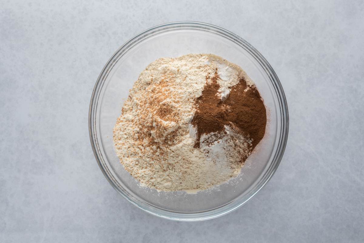 flour, cinnamon, sugar, and baking agents in a bowl.