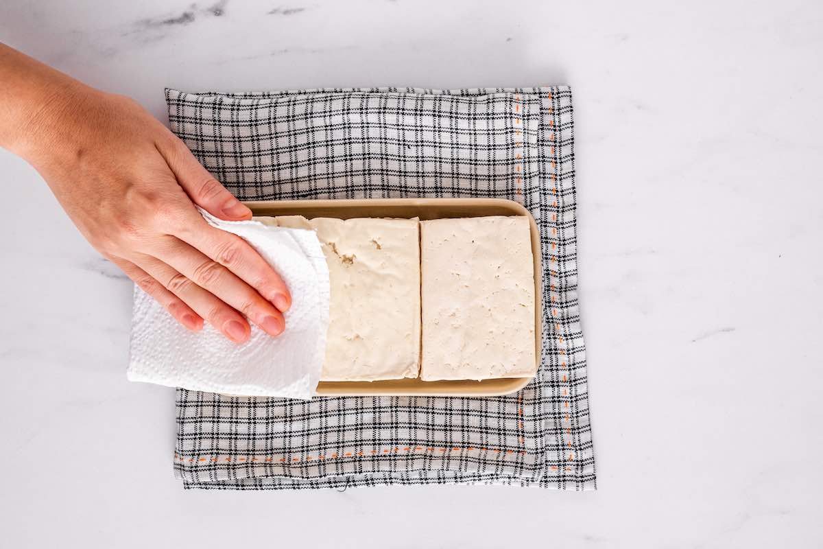 pressing tofu and soaking up moisture with a paper towel.