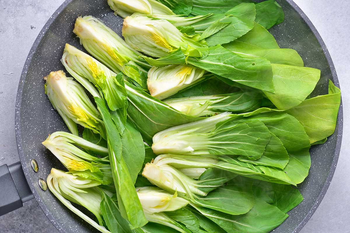 raw bok choy in a skillet.