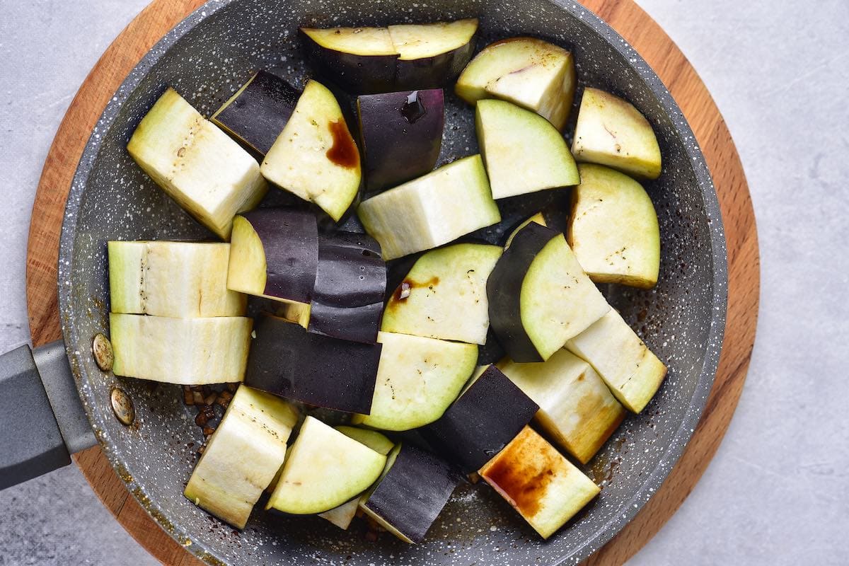 raw eggplant chunks in the skillet.