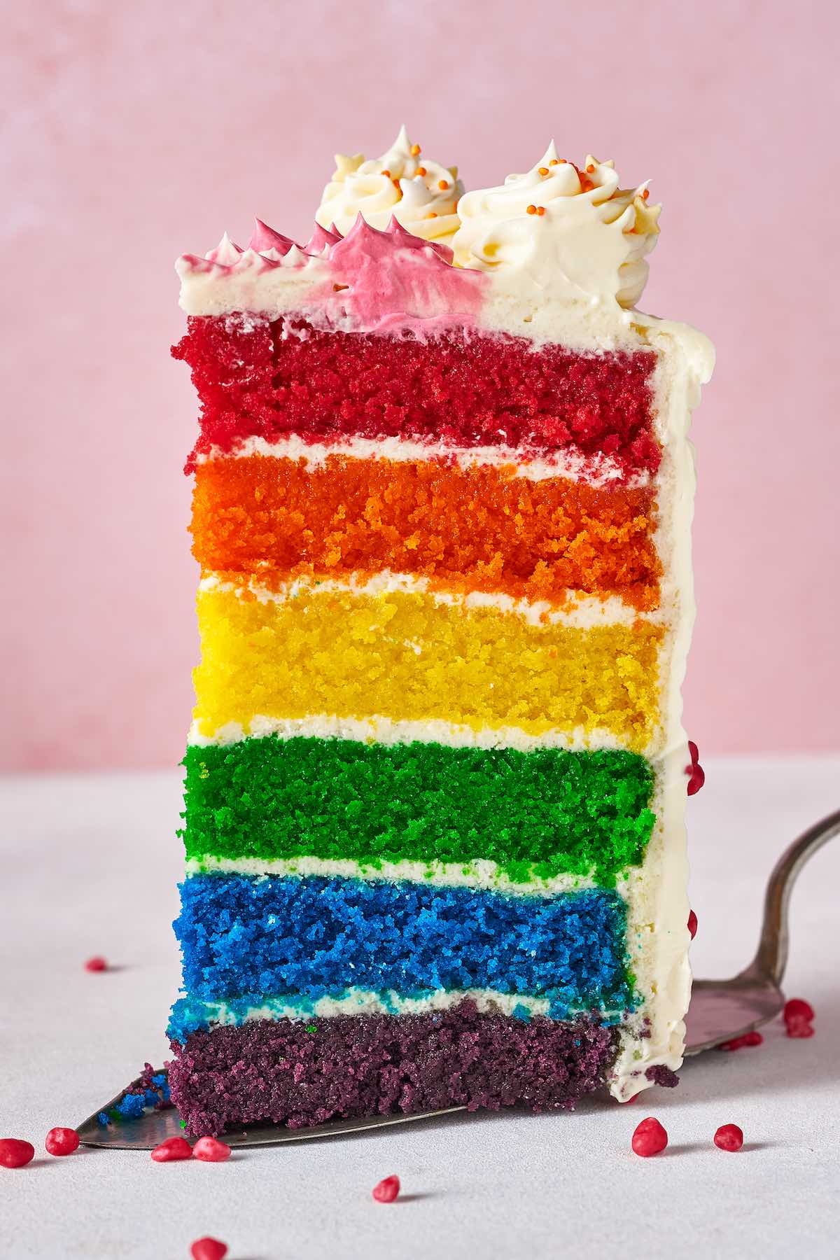 slice of homemade rainbow cake.