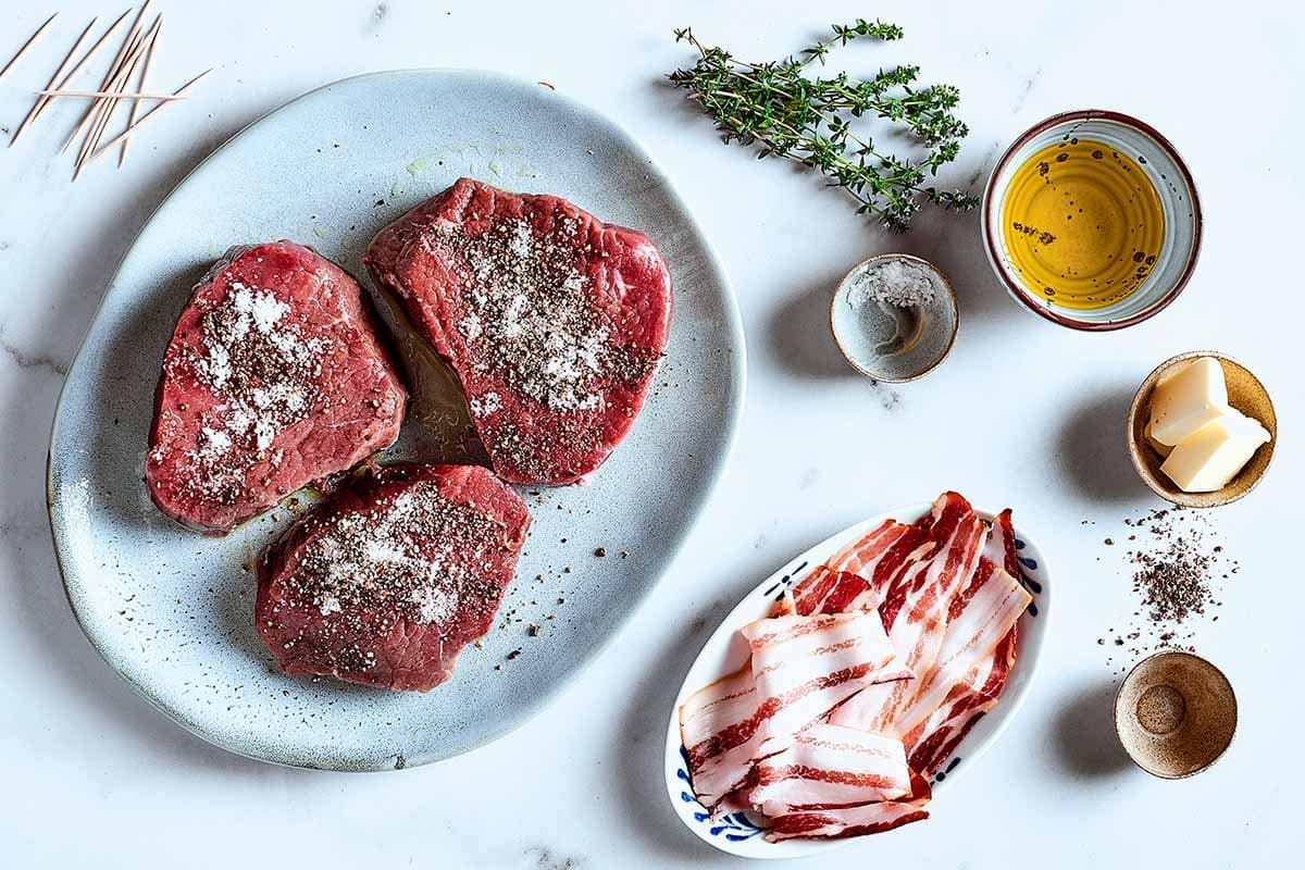 seasoned steaks on a plate.