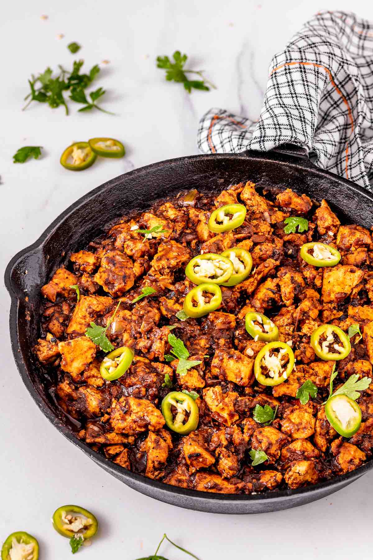 sofritas in a skillet with sliced jalapenos.