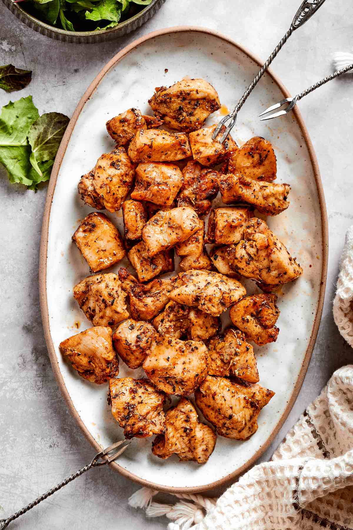 air fryer chicken bites on a plate with dipping sauces.