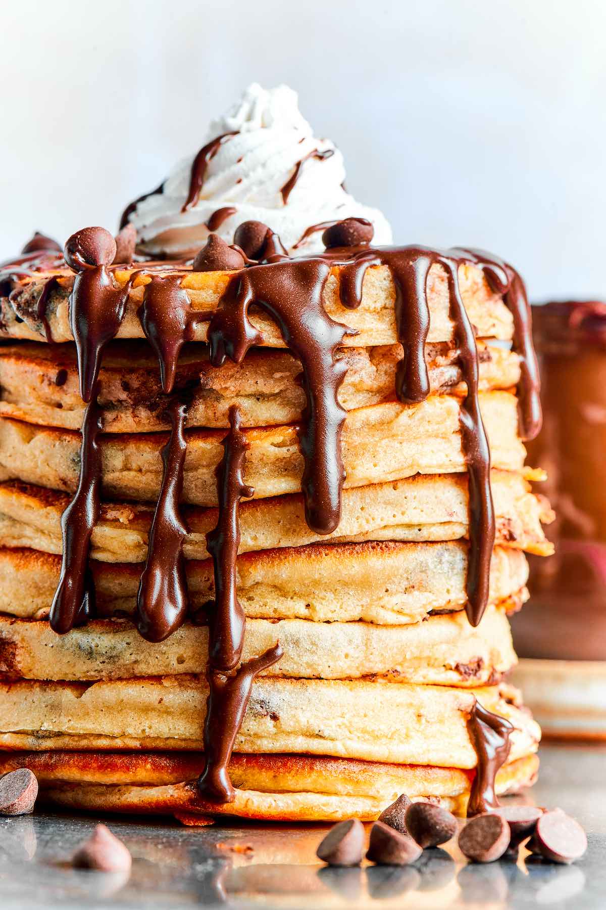 chocolate chip pancakes with whipped cream on top.