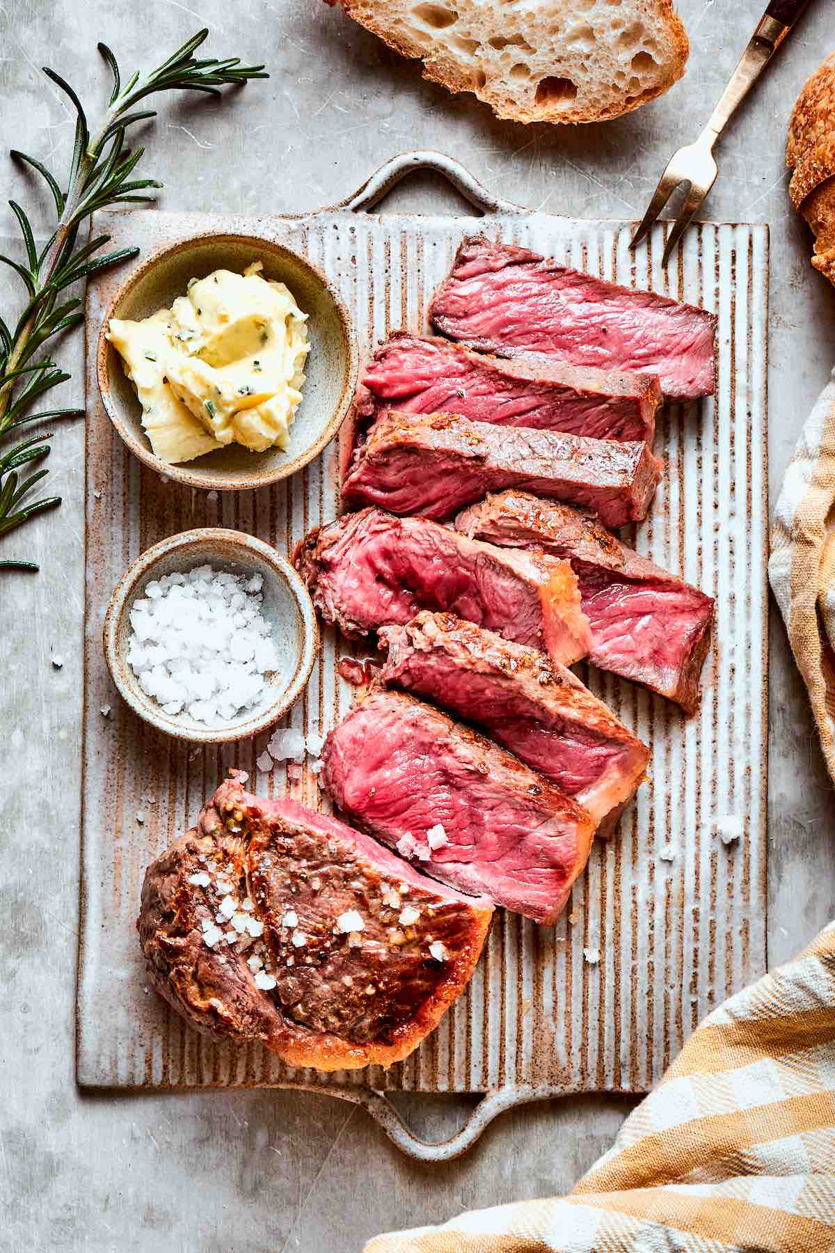 sliced chuck eye steak with sea salt on top.