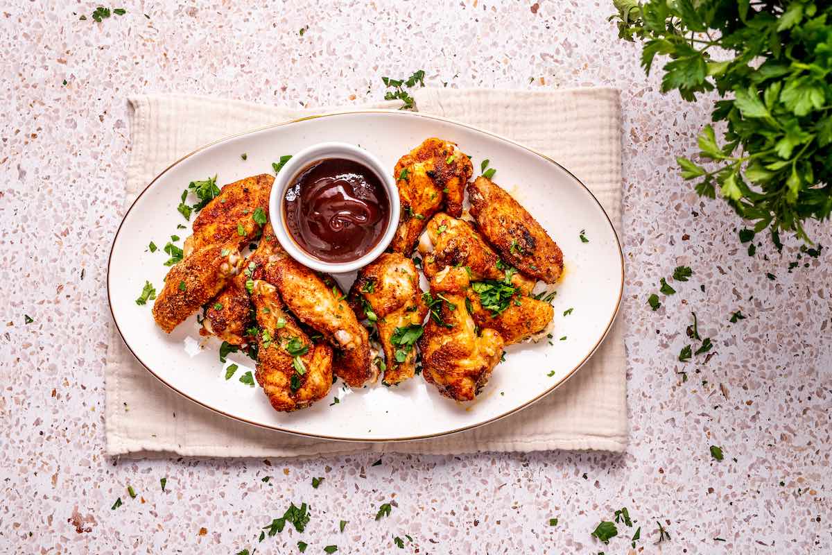 crispy baked chicken wings on a plate.