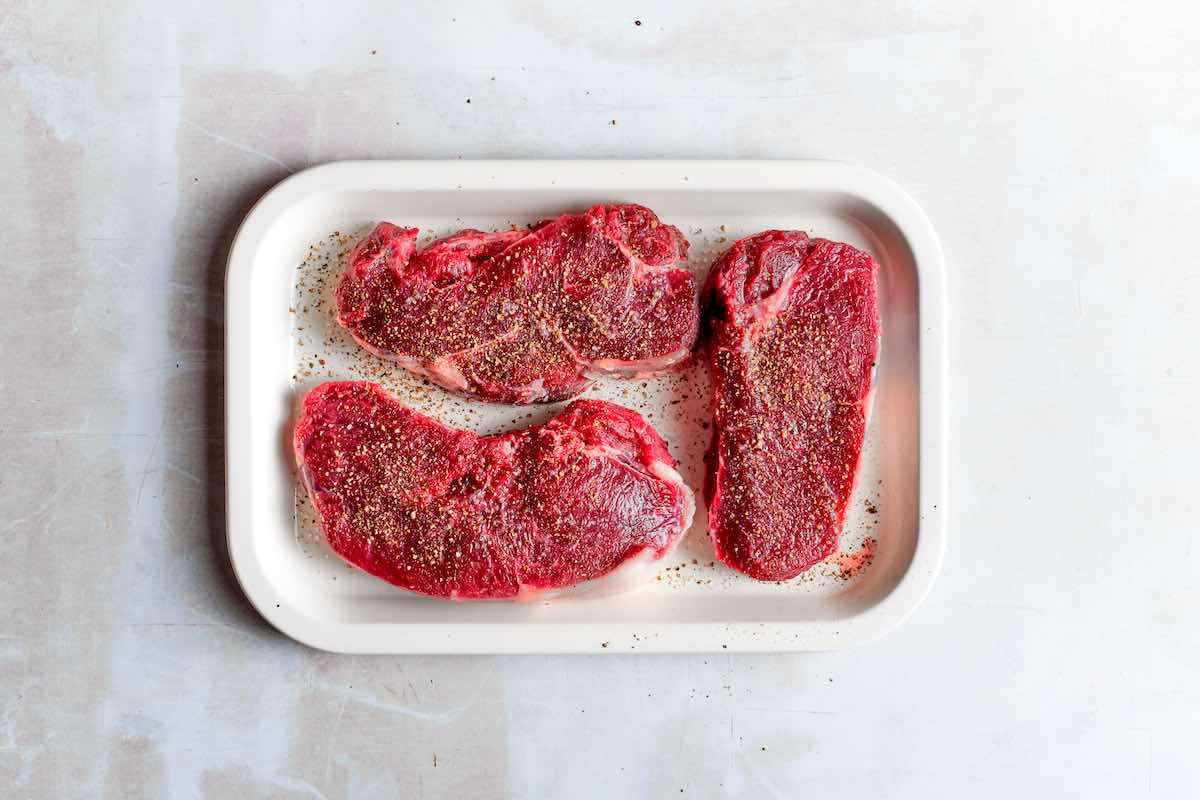 seasoned raw steaks.