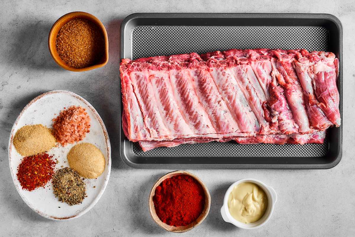 rack of ribs and seasonings on a plate.