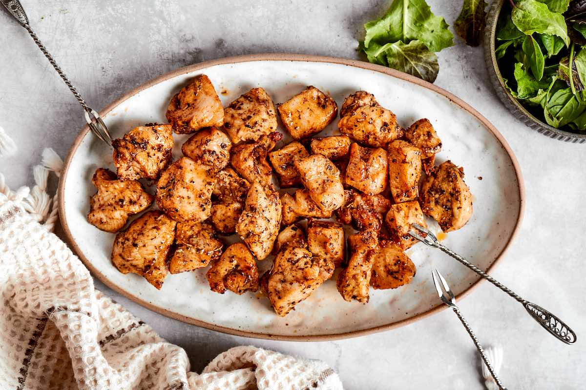 air fried bites of chicken on a serving plate.