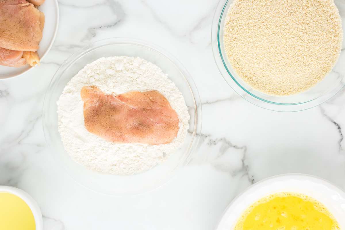 raw chicken cutlets in flour.