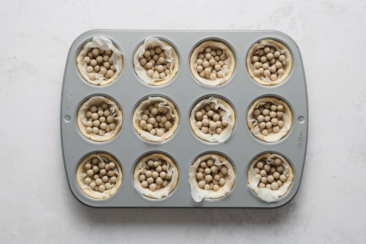 dough pressed into muffin tin.