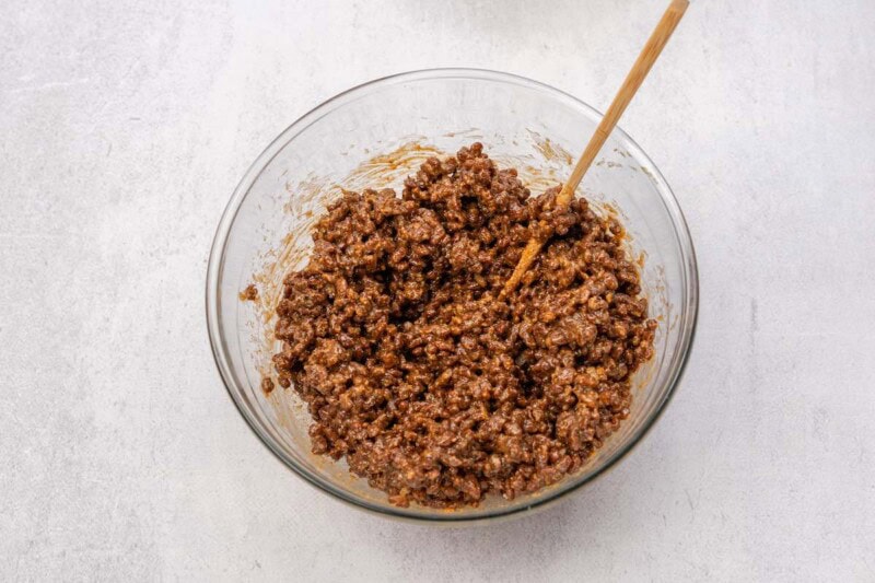 chocolate cereal, peanut butter, and maple syrup in a bowl.