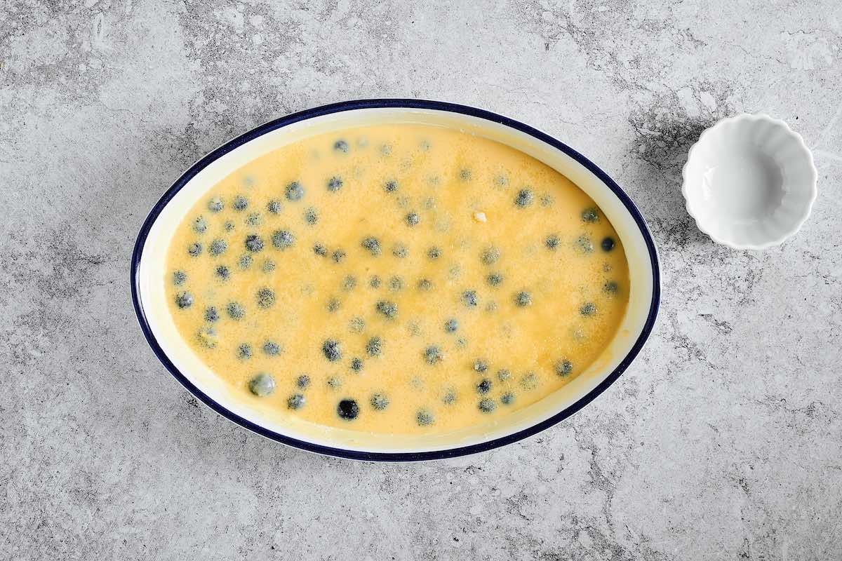 custard mixture over cherries and blueberries.