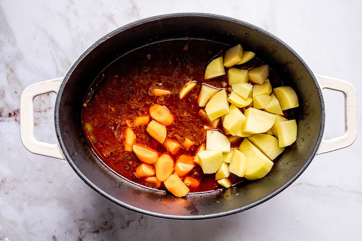 chopped potatoes and carrots added to Dutch oven.