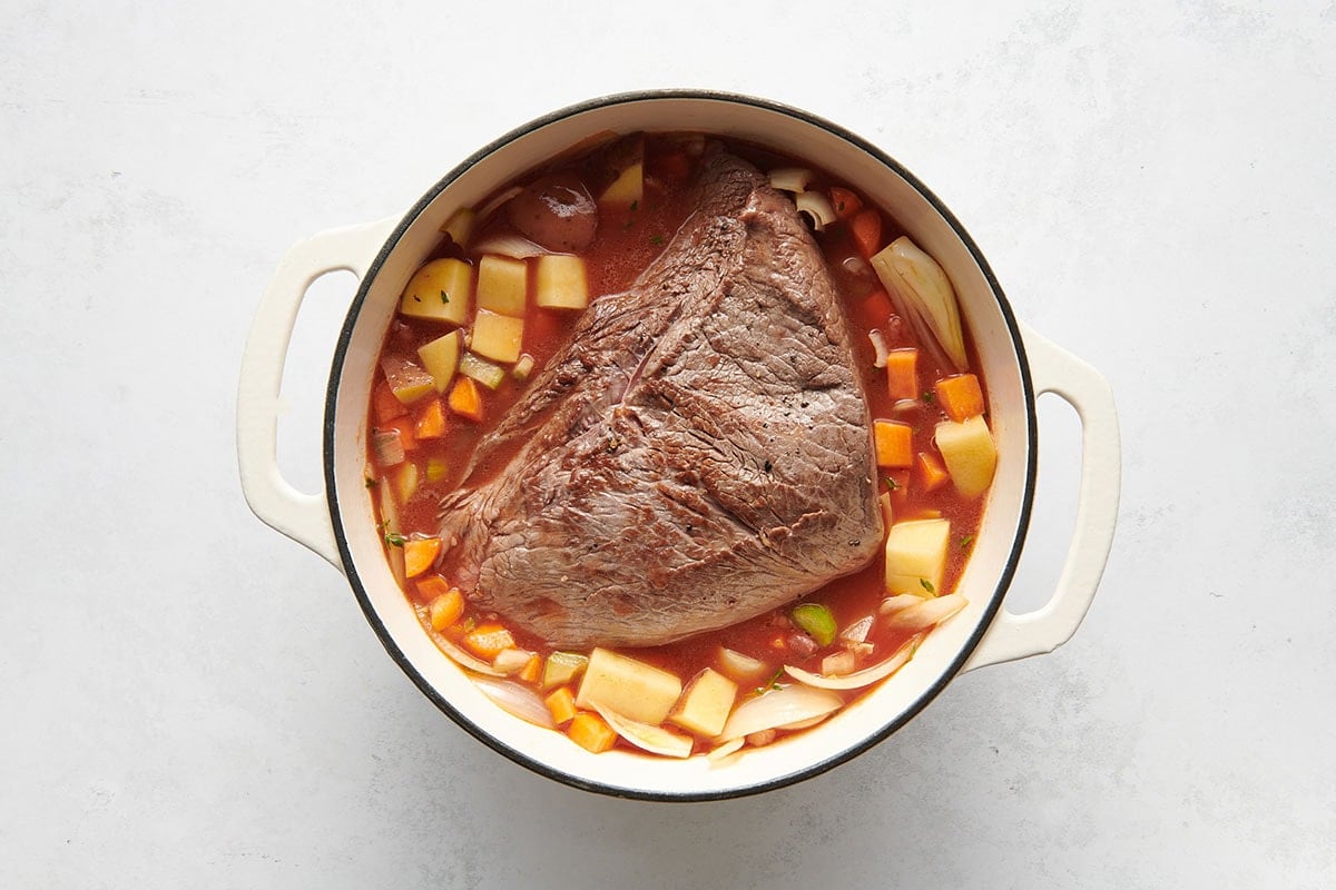 potatoes, broth, and roast in Dutch oven.