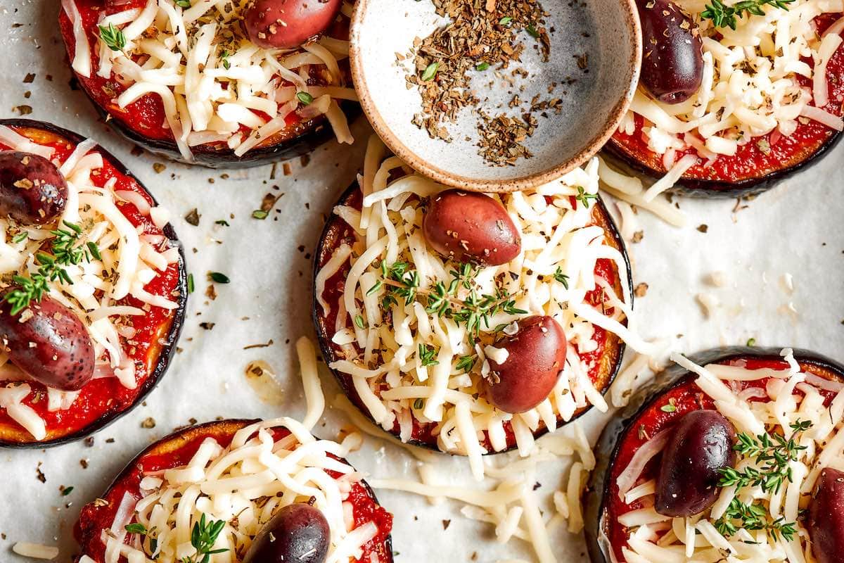 baked eggplant rounds with tomato sauce and cheese on top.