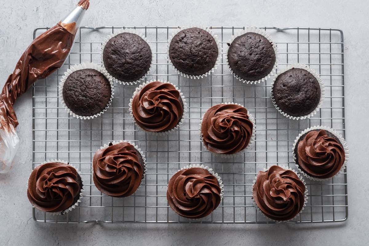 adding healthy frosting to cupcakes.