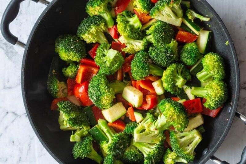 raw vegetables in a skillet.