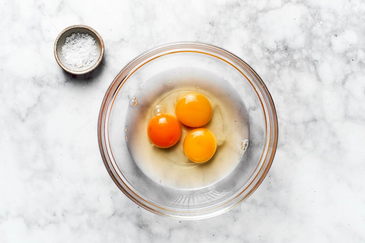 raw eggs in a greased bowl.