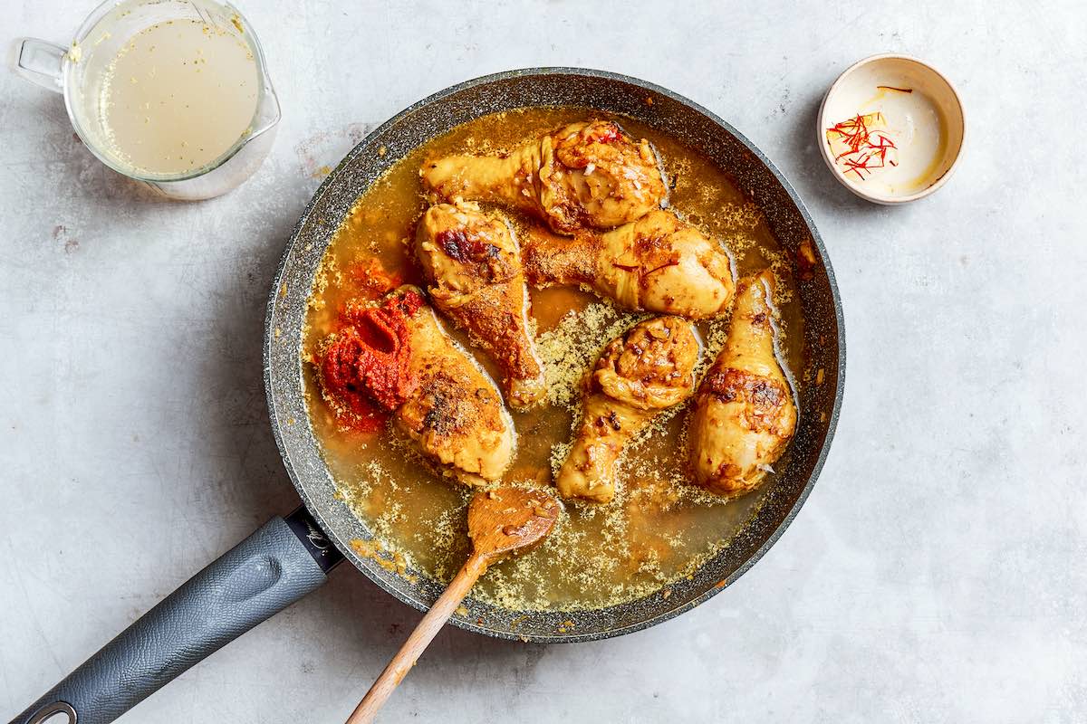 chicken, broth, and seasonings in a skillet.