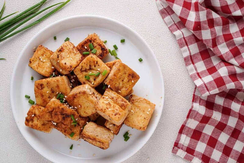 fried tofu with fresh herbs on top.