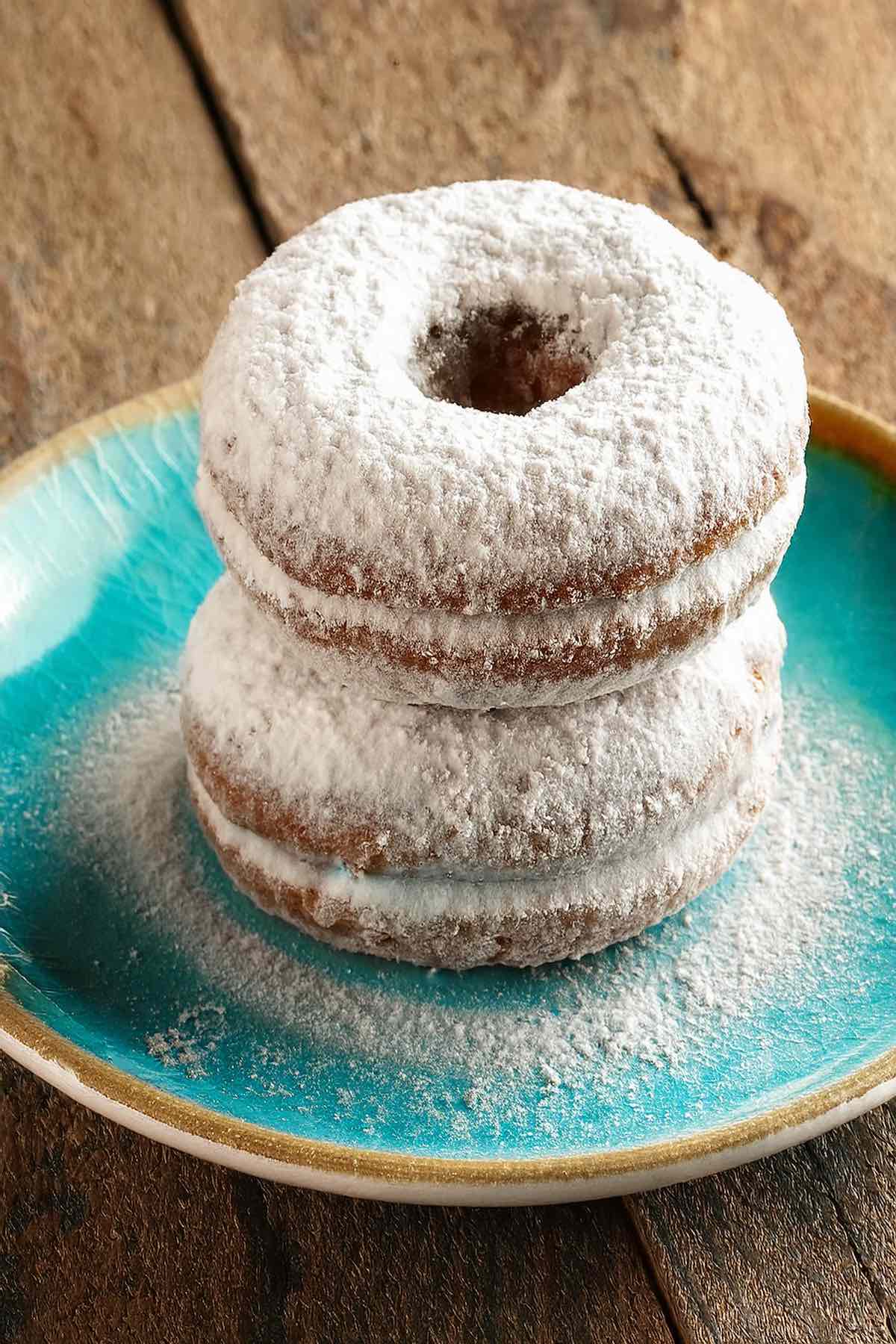 powdered donuts on a plate.