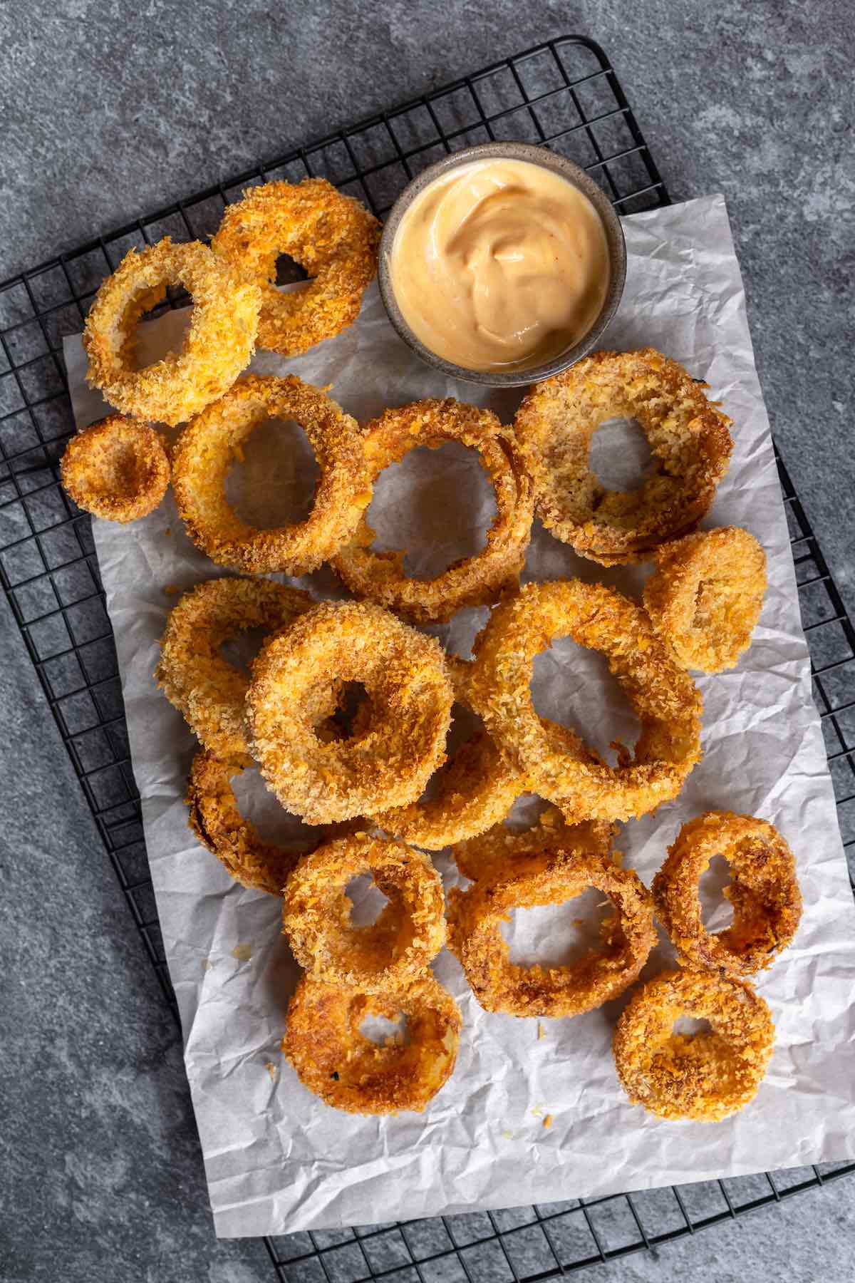 crispy air fryer onion rings on a baking sheet.