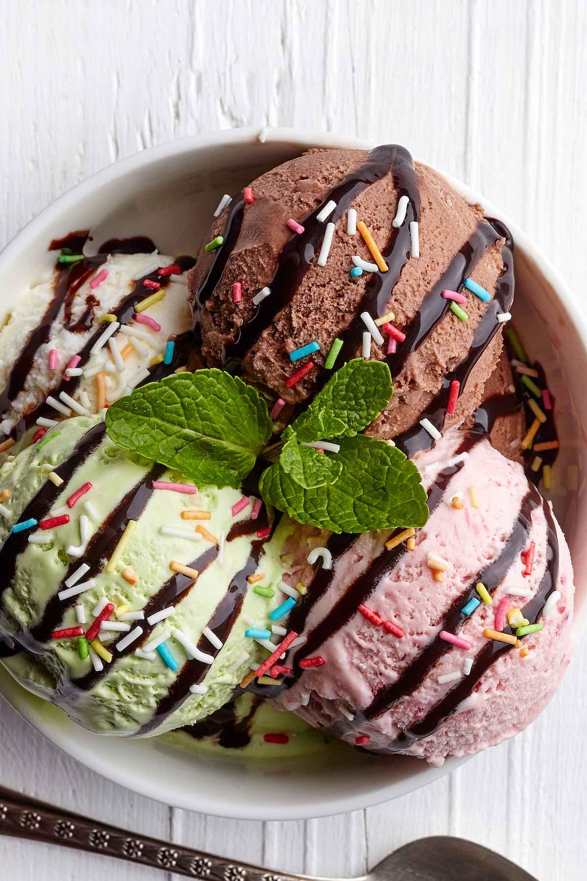 bowl of blender ice cream in chocolate, vanilla, mint, and strawberry.