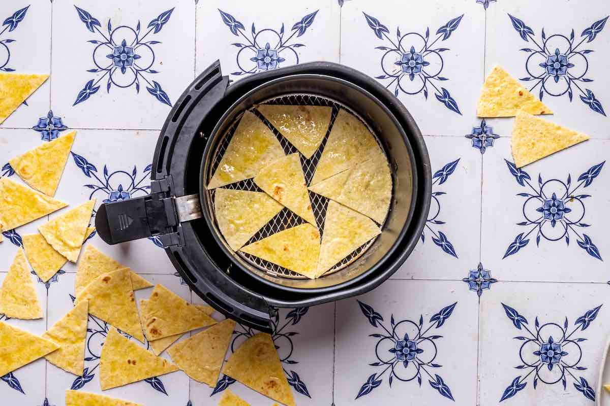 seasoned tortilla chips in the air fryer basket.