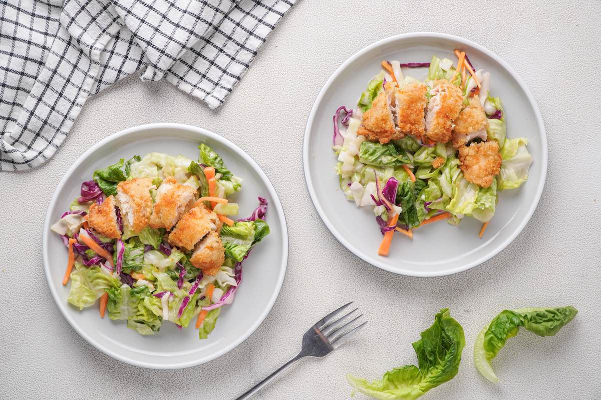 assembled chicken salad on plates.