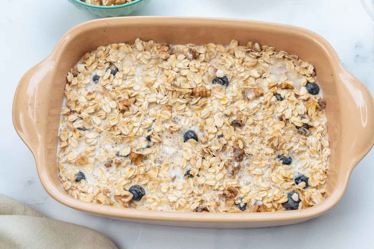 oats, almond butter, blueberries, and banana in a baking dish.