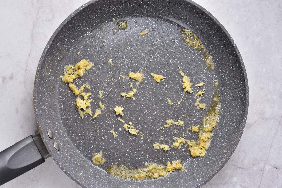 minced garlic sauteing in a pan.