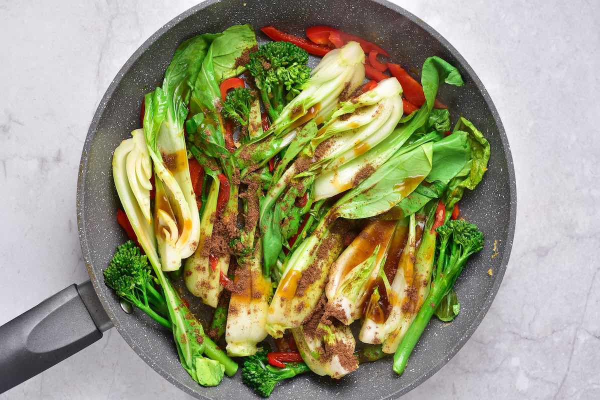 raw vegetables and seasonings in the pan.