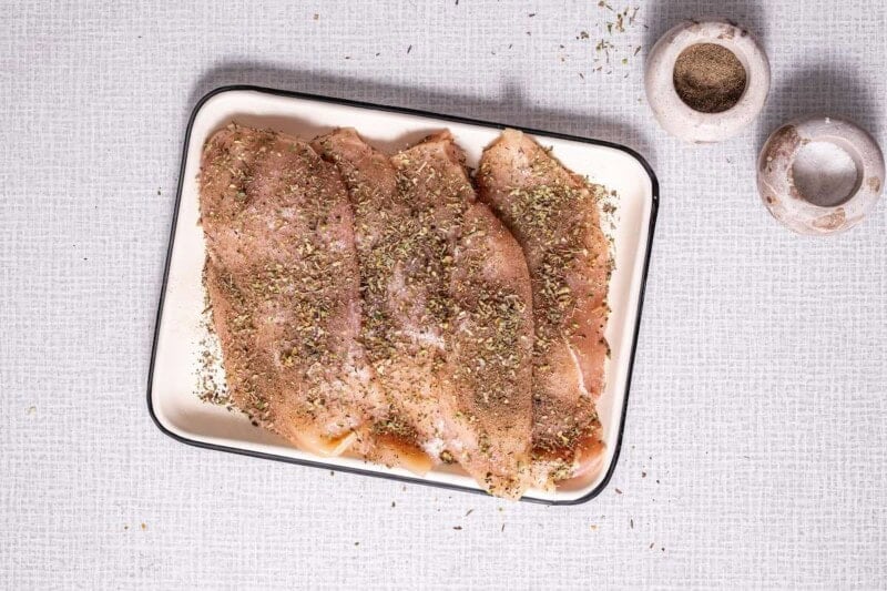 seasoned raw chicken breasts.