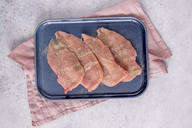 pounded and seasoned raw chicken breasts.