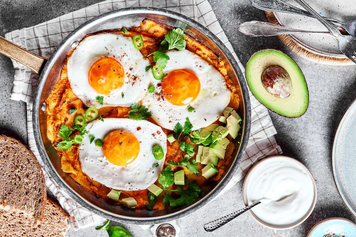 assembled chilaquiles with fried eggs on top.