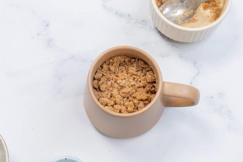 coffee mug cake with streusel on top.