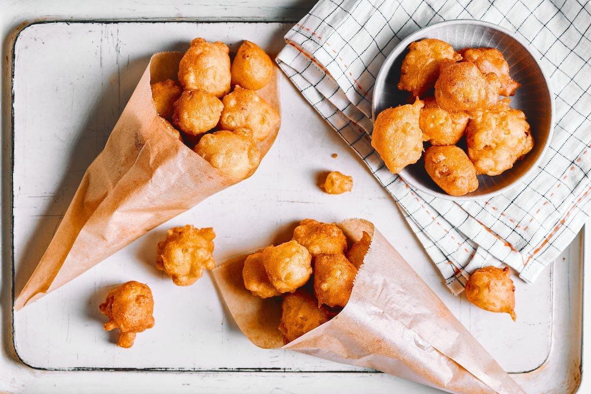 crispy fried corn nuggets on a serving dish.