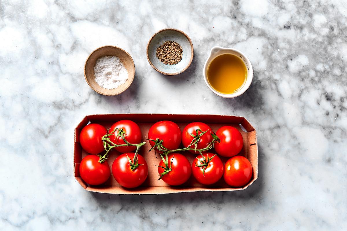 raw tomatoes and seasonings in bowls.