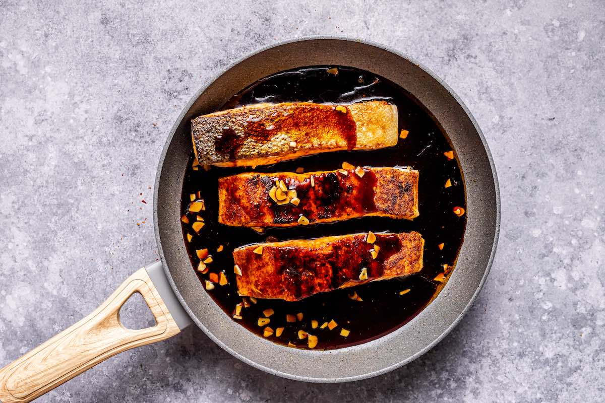 seared salmon fillets with honey garlic sauce on top.