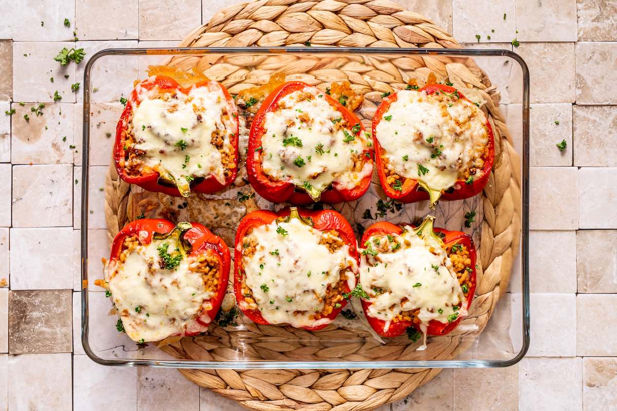 freshly baked stuffed peppers in a baking dish.