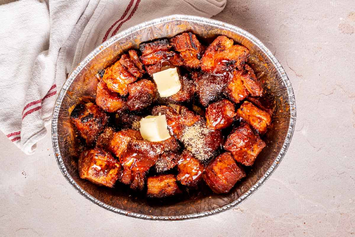 smoked pork belly bites with butter, honey, and sugar on top.